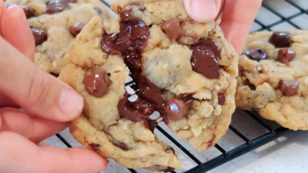 warm chocolate chip cookie-pulling it in half, doubletree chocolate chip cookies. doubletree cookie.