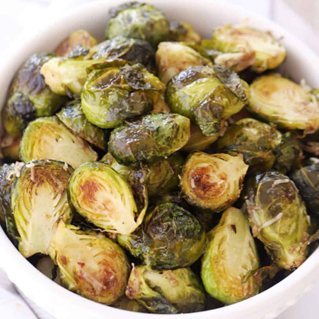 Roasted Brussels sprouts in a serving dish. best thanksgiving side dishes.