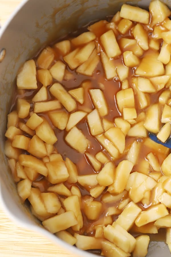 Apples cooking in a pot for apple monkey bread. Best apple dessert recipes. Cinnamon monkey bread.