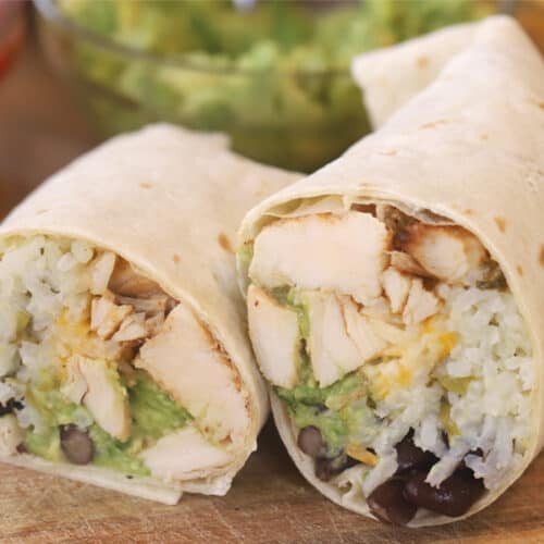 chipotle burrito made with Chipotle chicken recipe, black beans, salsa, and guacamole. Best chipotle burrito recipe.
