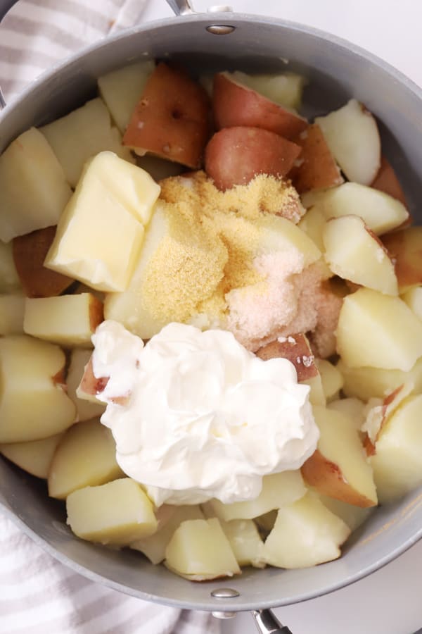 ingredients for red potatoes mashed in a large pot.