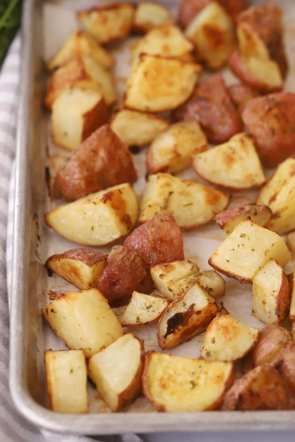 crispy Roasted Ranch potatoes on a sheet tray, crispy ranch potatoes in the oven, ranch roasted potatoes, ranch potatoes in oven.