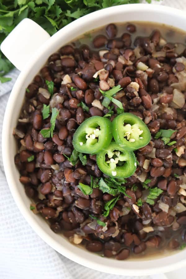 Copycat chipotle black beans in a white serving dish, recipe for chipotle black beans.