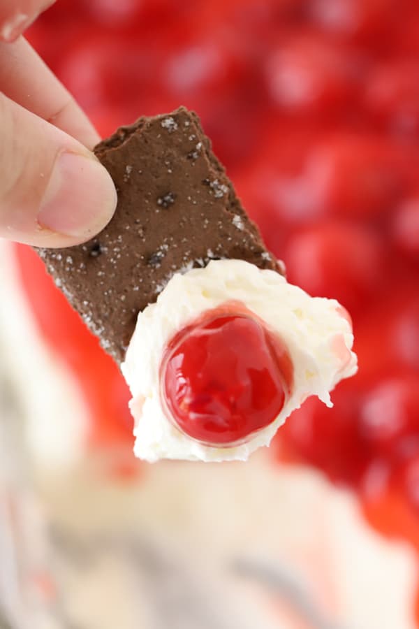 cherry cheesecake dip on a chocolate graham cracker