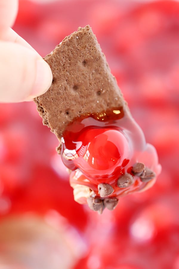 cherry cheesecake dip on a chocolate graham cracker