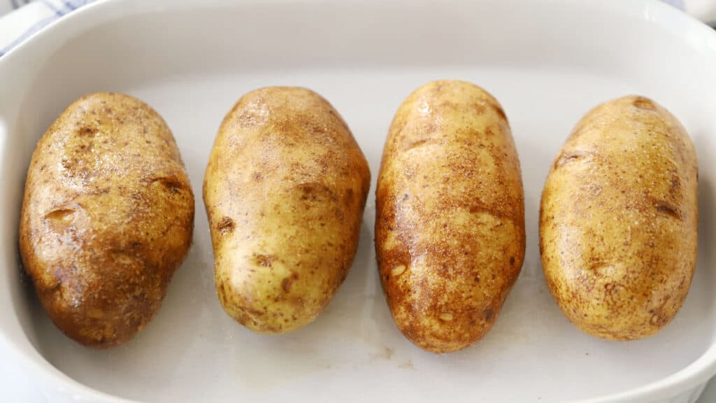 uncooked potato in a baking dish.