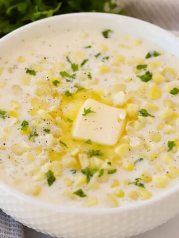 homemade cream of corn in a large white bowl, homemade creamed corn.