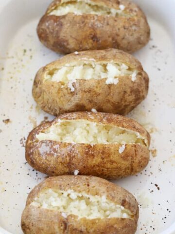 fluffy baked potatoes in a white baking dish