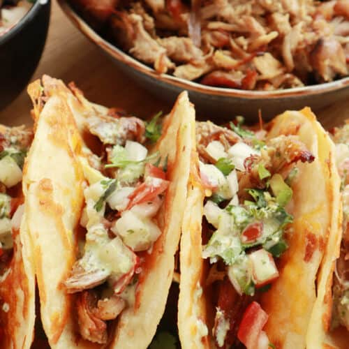 pork carnitas slow cooker recipe stuffed into crispy taco shells.