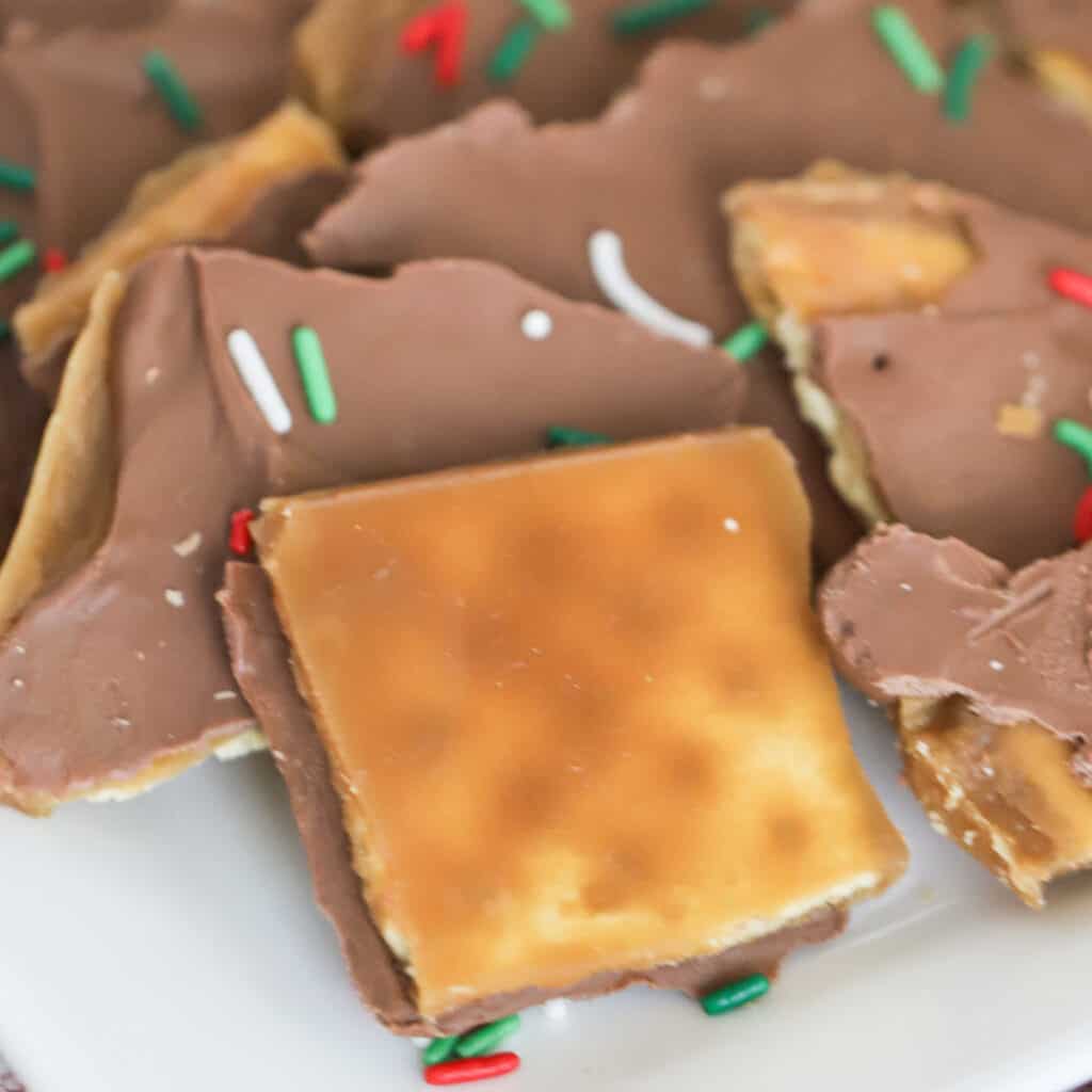 saltine cracker toffee recipe on a white plate, saltine toffee recipe, cracker candy saltines.