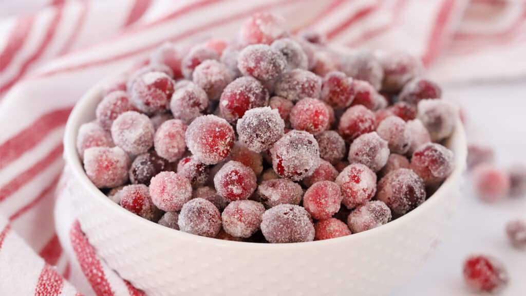 Sugar cranberries in a white serving bowl, this recipe will show you how to sugar cranberries.