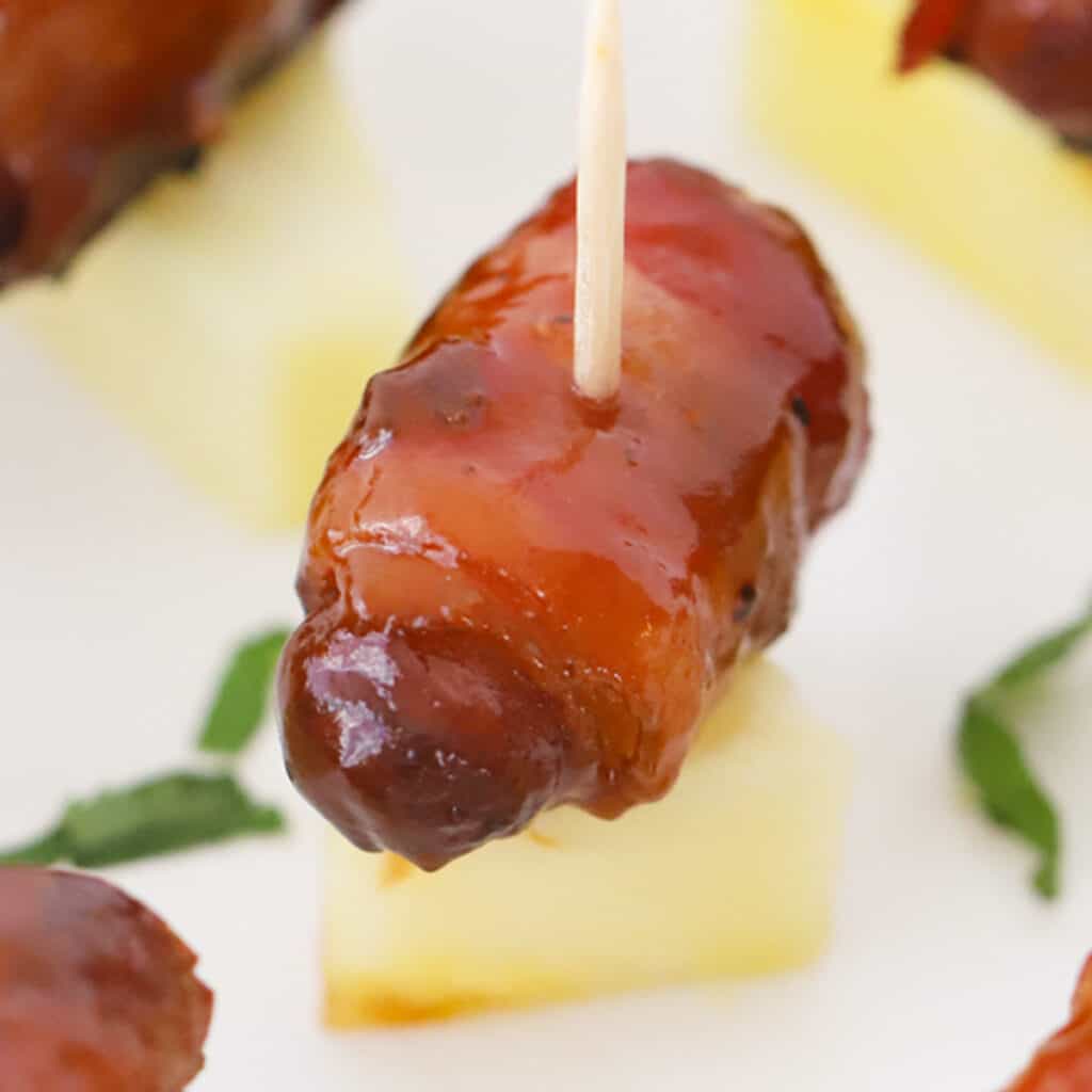 bacon wrapped smokies on pineapple, one of the best food for game day.