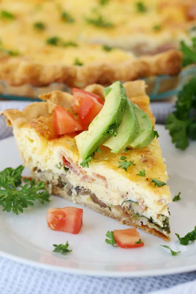 bacon and mushroom quiche recipe with avovado and tomato slices on top, a healthy breakfast recipe.
