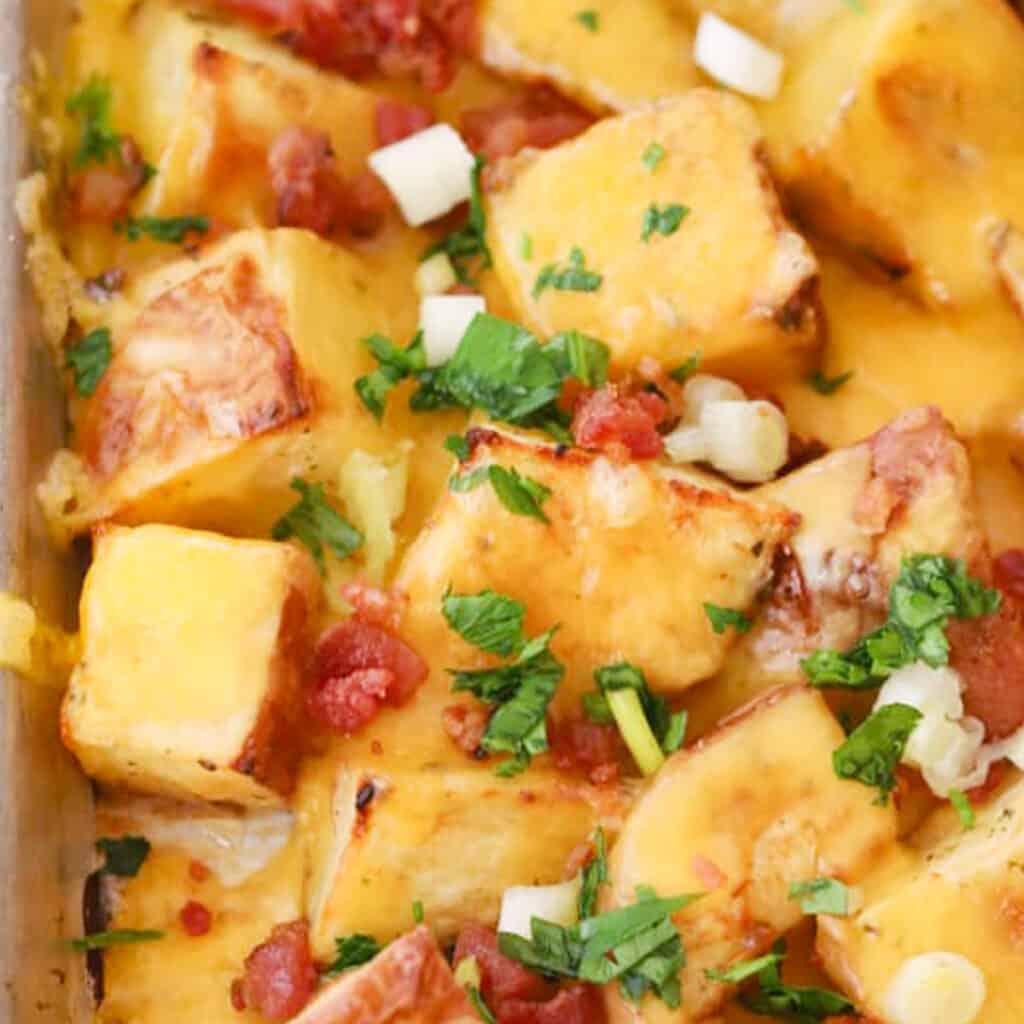 cheesy ranch potatoes on a baking sheet, cheesy bacon potatoes recipe