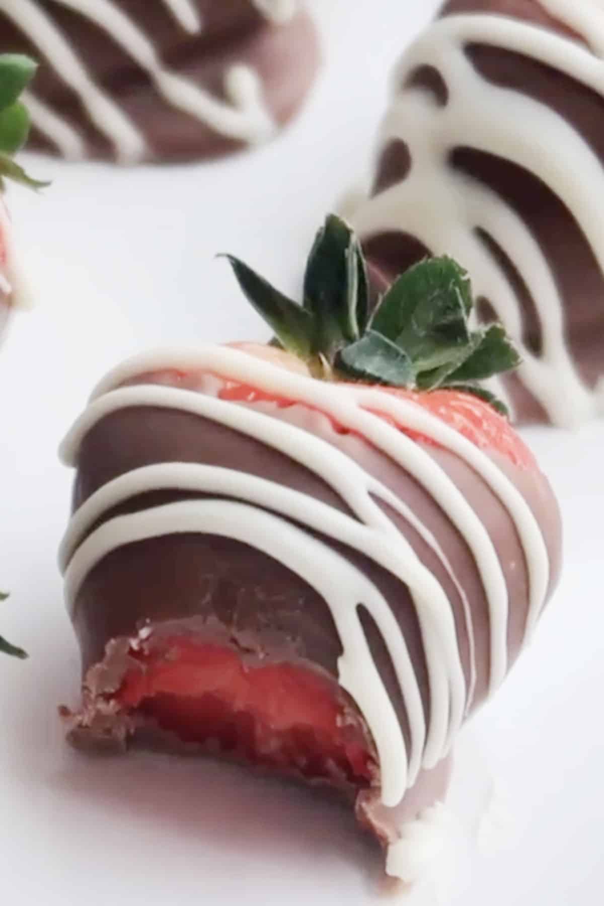 DIY chocolate dipped strawberry with a bite taken out, how to store chocolate covered strawberries, storing chocolate covered strawberries. 