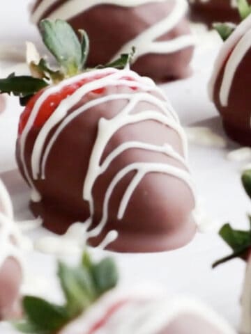 chocolate dipped strawberries on a white serving tray