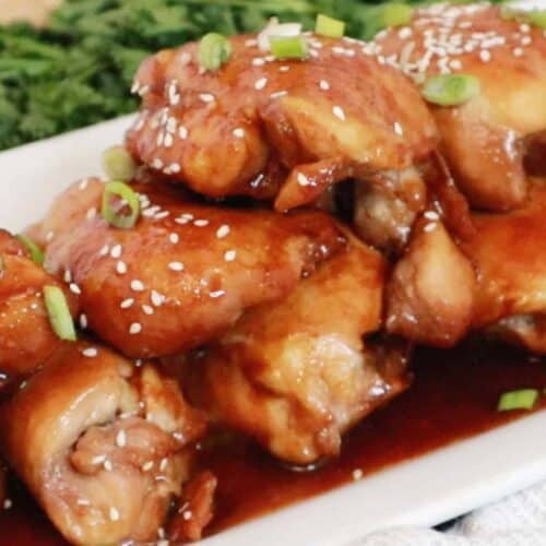Honey Soy Chicken Thighs on a white platter, baked honey soy chicken thighs.