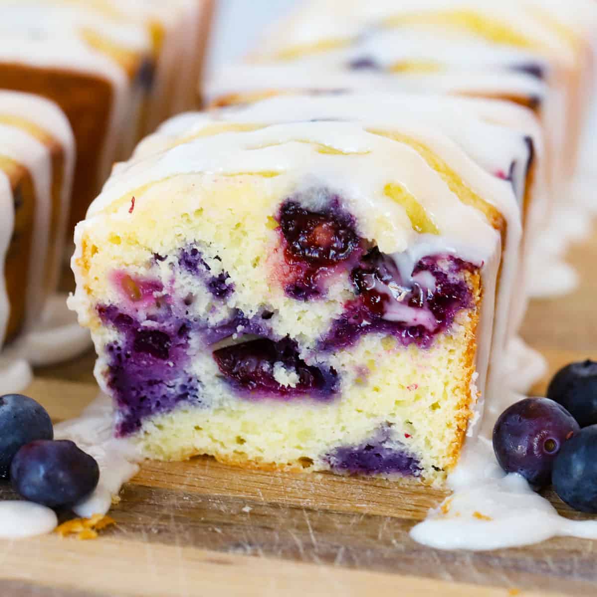 blueberry mini loaves on a wood cutting board