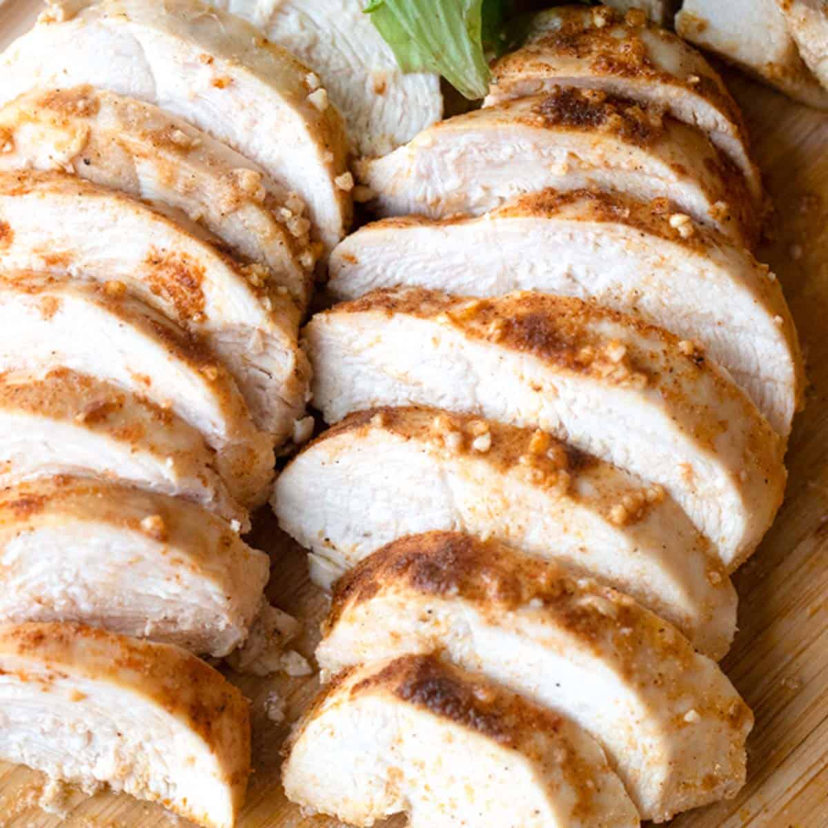 best baked chicken breast on a wood cutting board, oven baked boneless chicken breast.