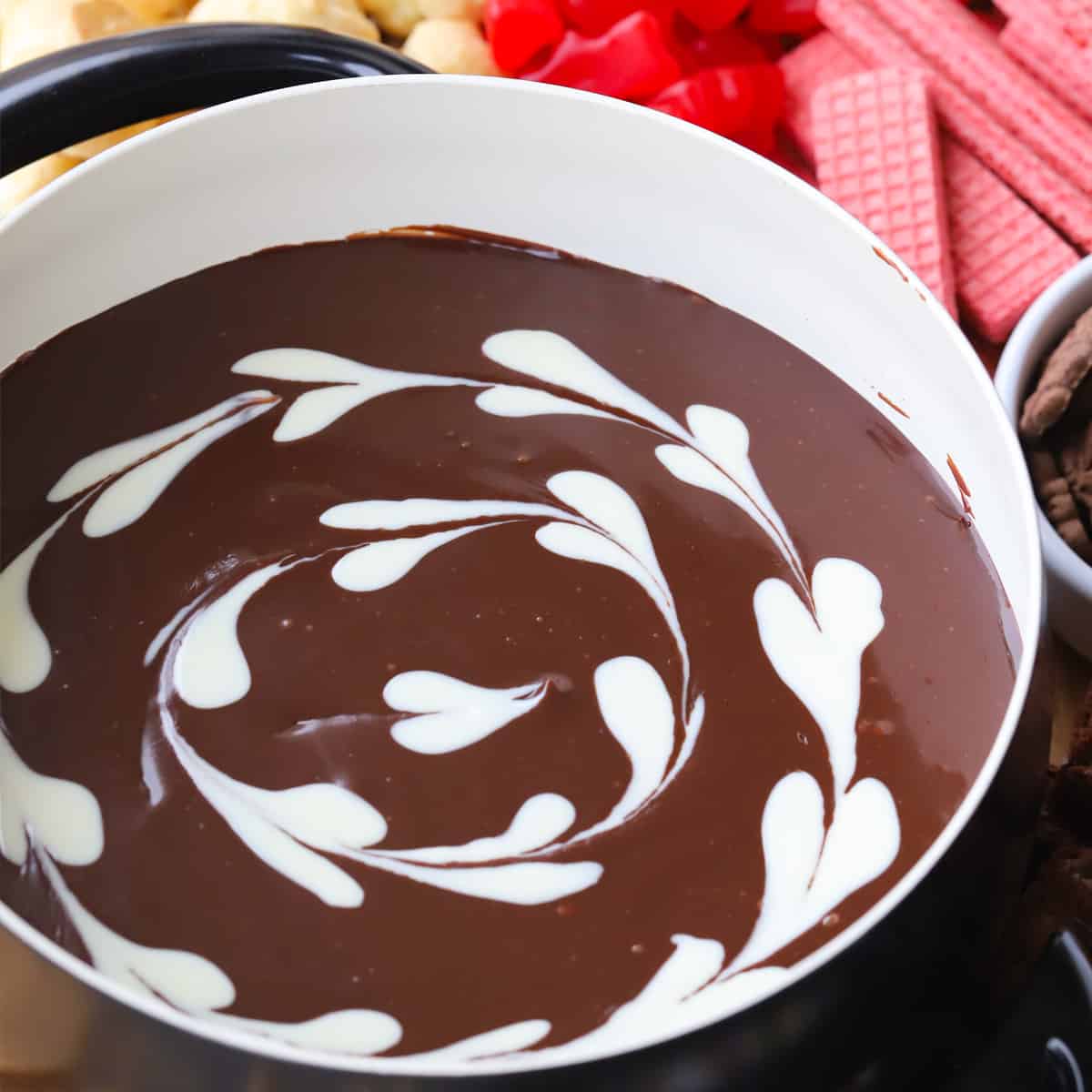 milk Chocolate fondue recipe with white chocolate hearts in a fondue pot, how to make chocolate fondue. best chocolate fondue recipe.