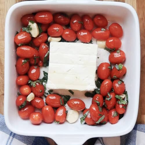 tortellini feta cheese pasta ingredients, ready to bake in a white baking dish