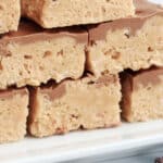 recipe for Scotcharoos stacked on top of each other on a plate, easy no bake cookie bars