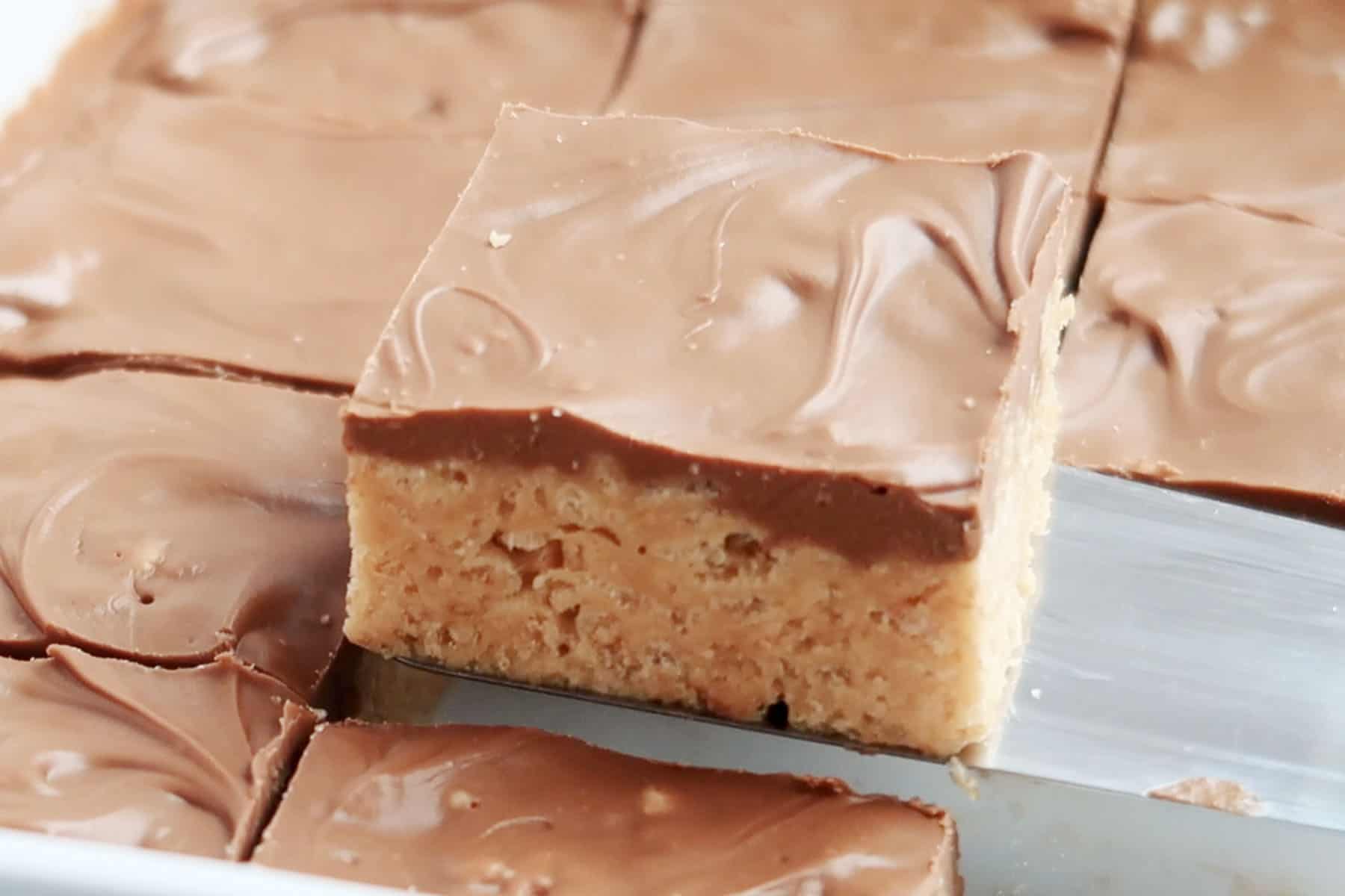 best scotcharoo recipes, easy no bake cookie bars being served on a spatula