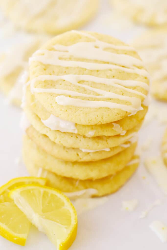 lemon cookies with lemon glaze, cookies stacked up on top of each other.