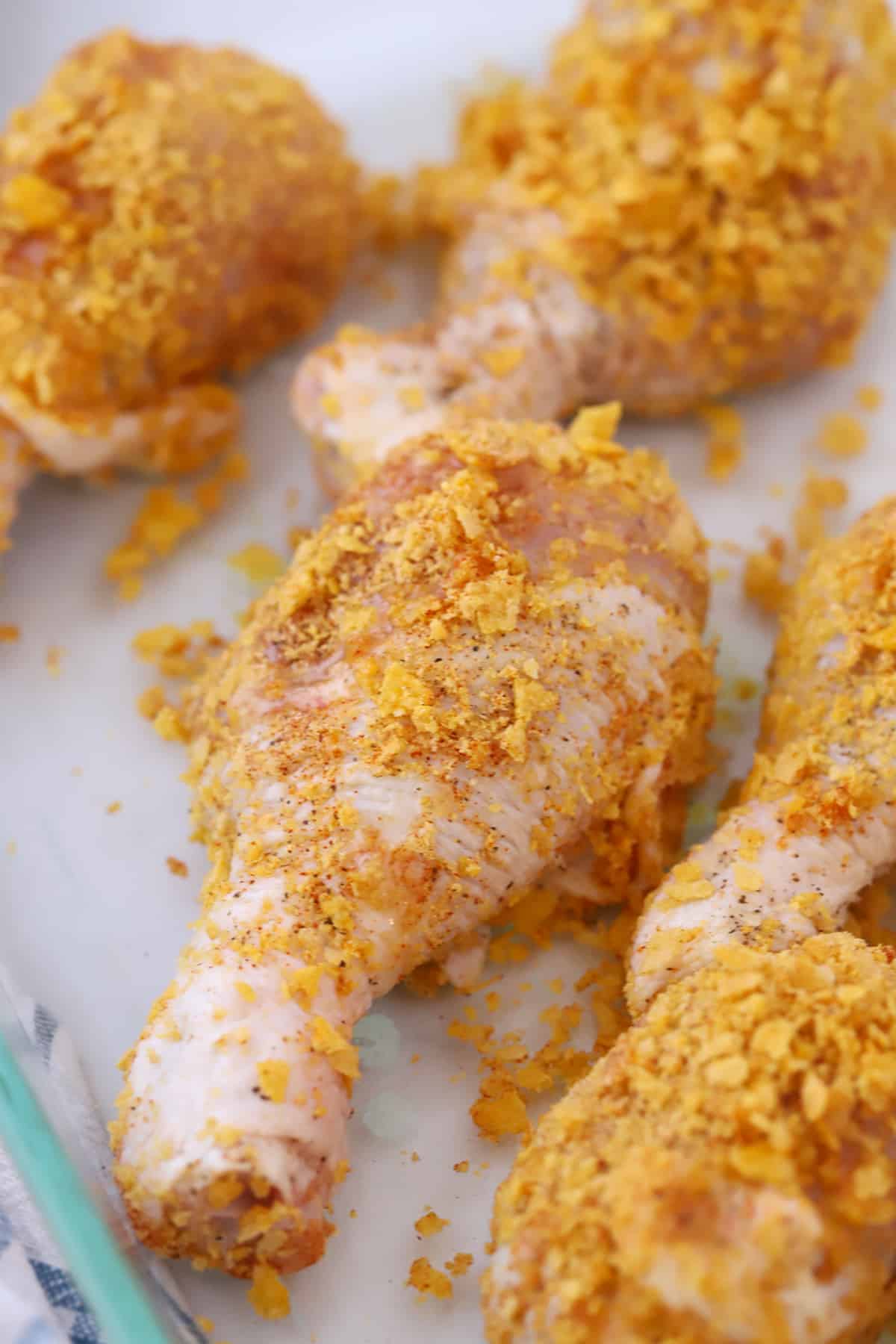 raw chicken drumsticks with cornflake coating