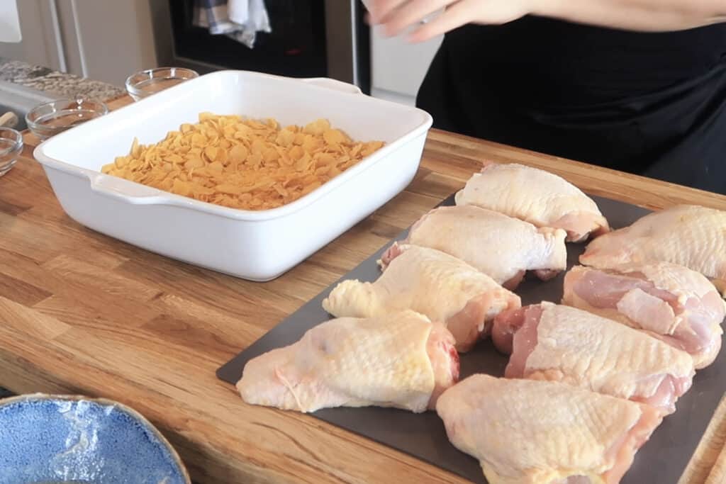 bone in chicken breasts and a white dish of crushed cornflakes, how to make corn flakes chicken. 
