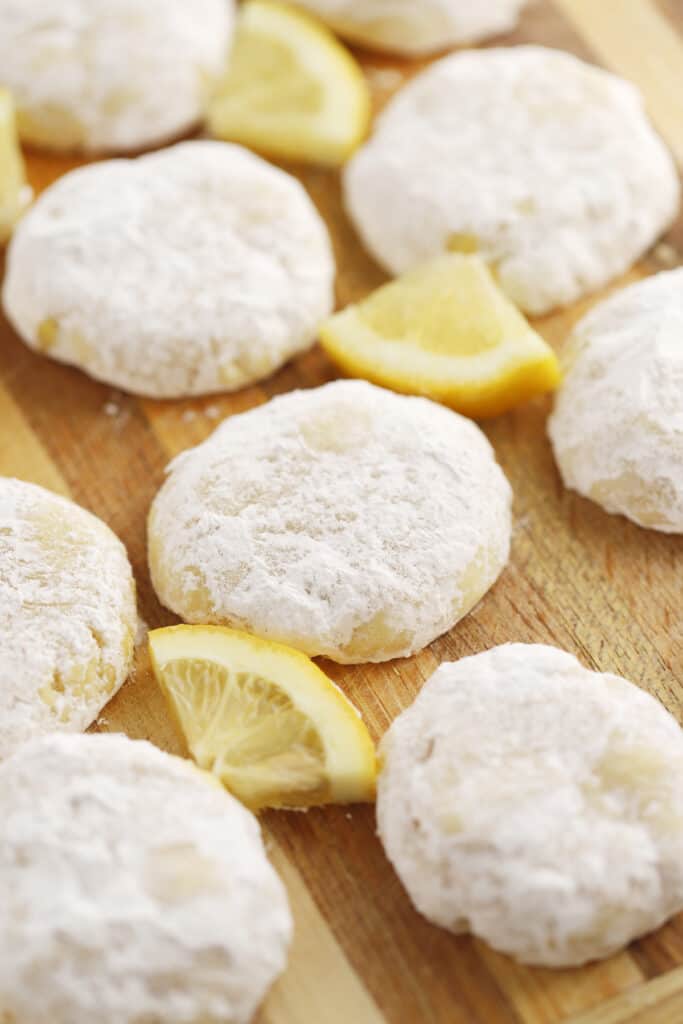 recipe for lemon cooler cookies on a wood cutting board, easy lemon cookies, lemon Italian cookies, lemon powdered sugar cookies. 