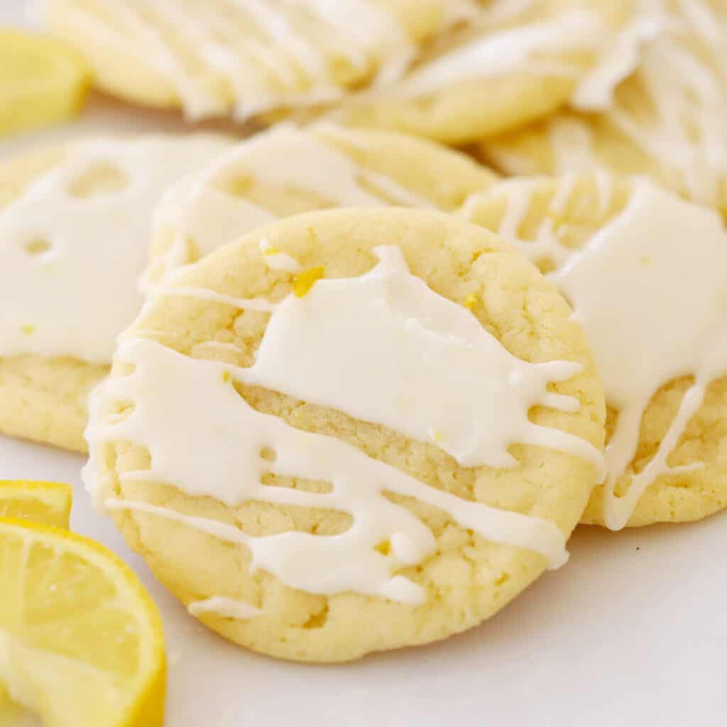 glazed lemon cookies on parchment paper, lemon glazed cookies.