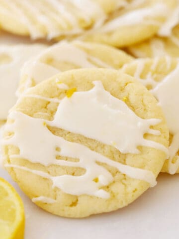 glazed lemon cookies on parchment paper, lemon glazed cookies.