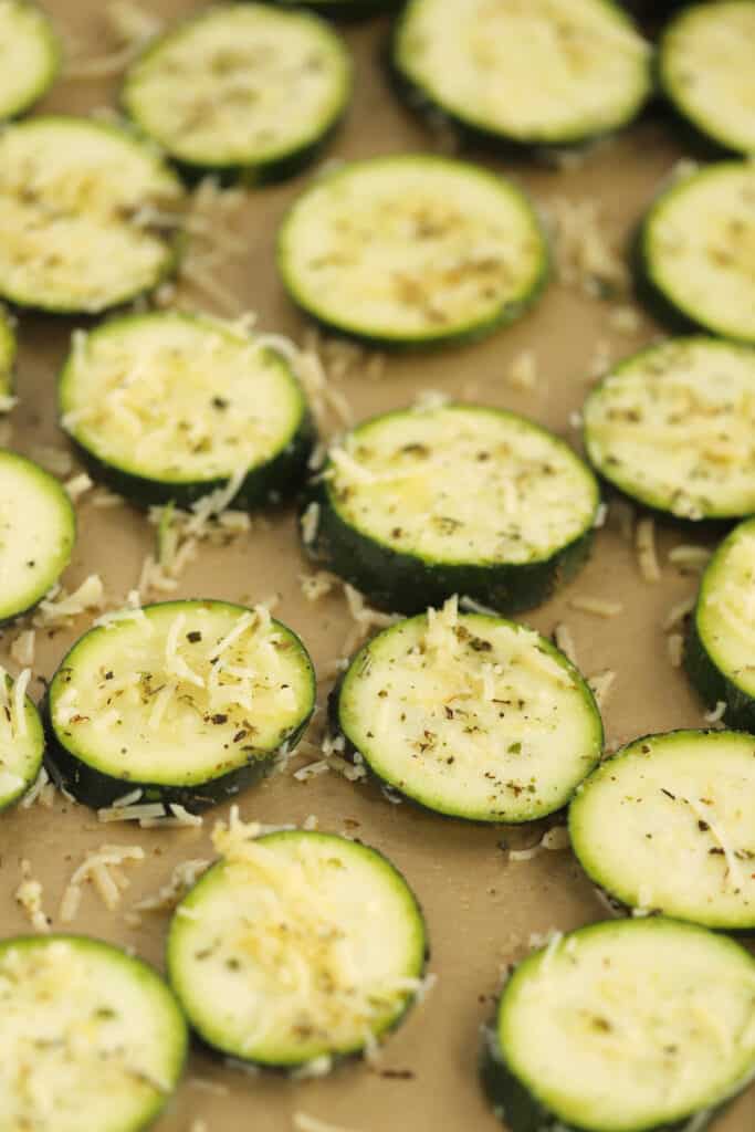 uncooked zucchini, ready to be baked on a baking sheet.