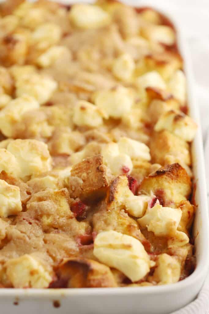 strawberry french toast bake recipe in a baking dish, overnight french toast bake, strawberry french toast casserole, stuffed strawberry french toast.