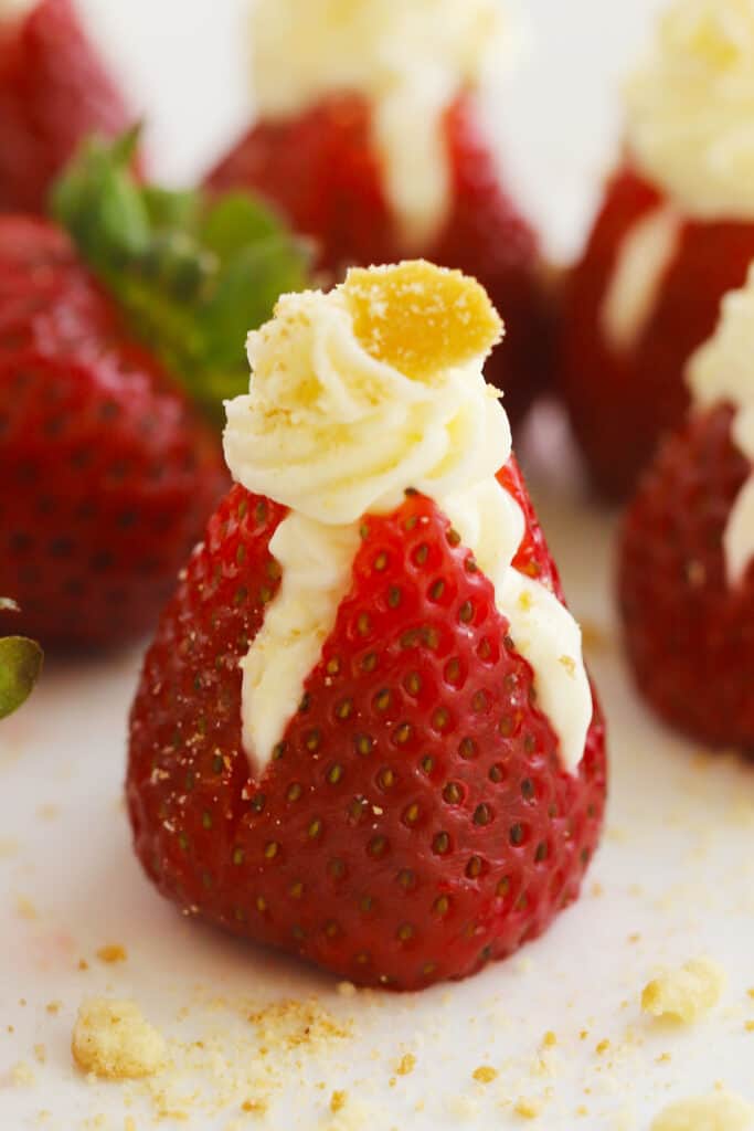 Cheesecake stuffed strawberries with cookie crumbs on top, white food ideas. blue food ideas, 4th of July recipes, 4th of July dessert recipes. 