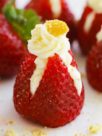 Cheesecake stuffed strawberries with cookie crumbs on top, strawberries stuffed with cream cheese.