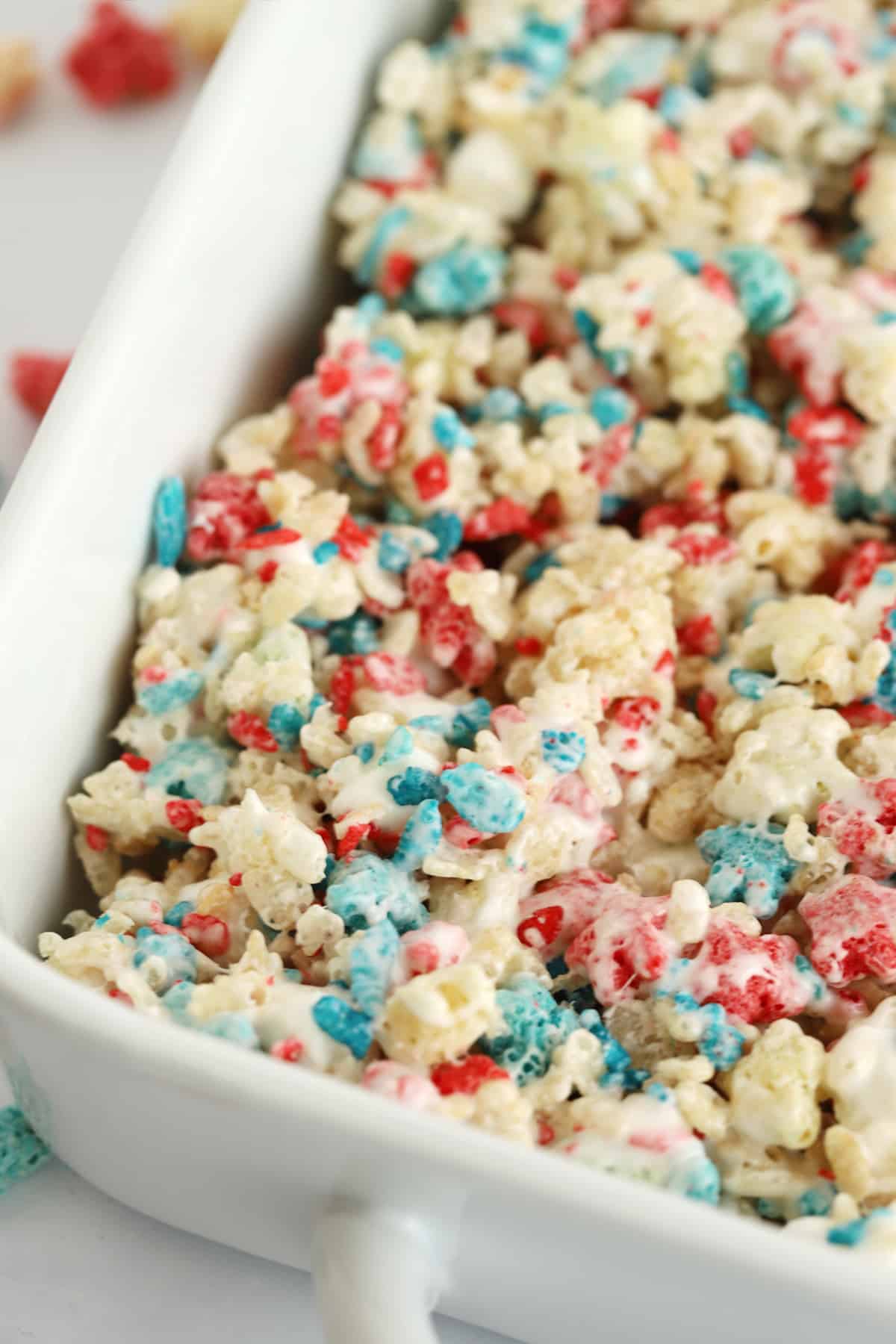 Red, white and blue rice krispies treats spread into a baking dish.