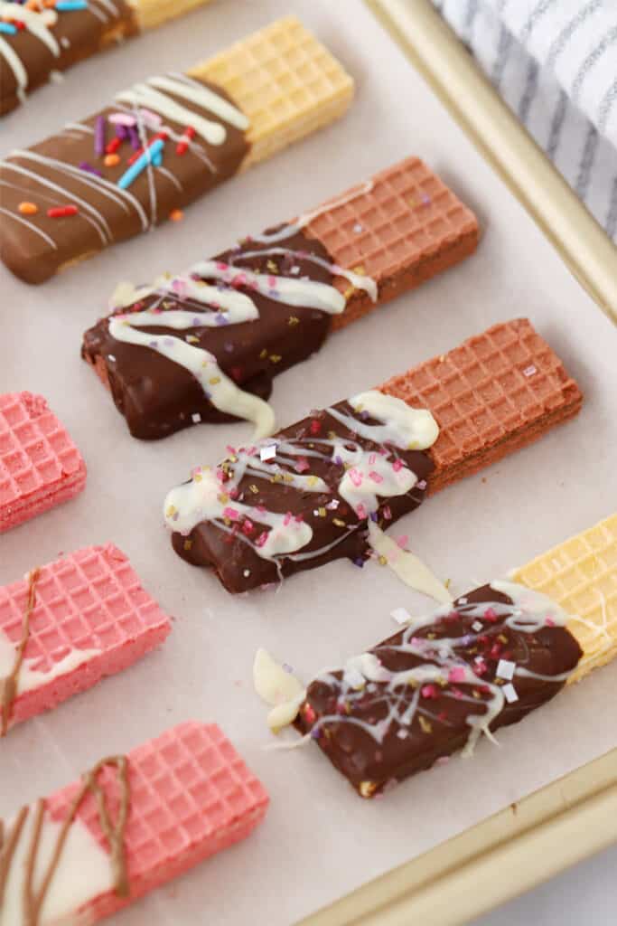Vanilla, pink, and chocolate wafer with chocolate coating and sprinkles.