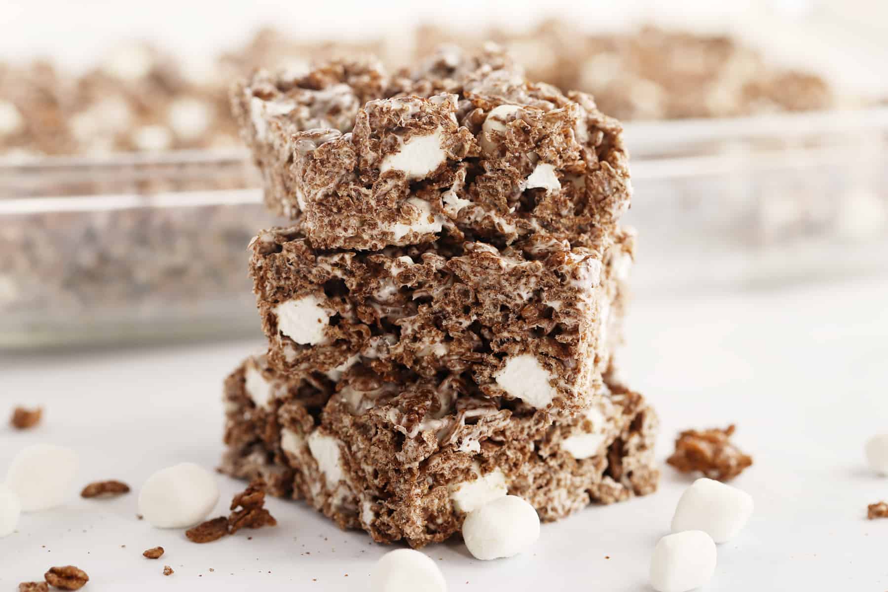 Chocolate Rice Krispies Treats cut and stacked on a tabletop.