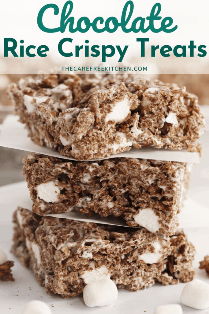 Chocolate Rice Krispies Treats stacked on top of each other, surrounded by mini marshmallows. no bake rice crispy treats.