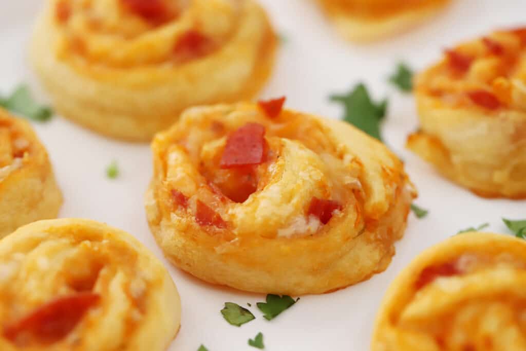 pepperoni pizza pinwheels on a white tray