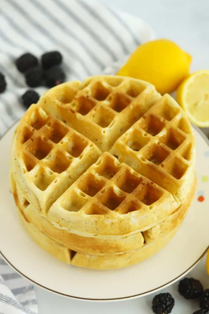 A stack of waffles on a white plate. waffle dough recipe, belgian waffles recipe easy, what makes a waffle belgian. 
