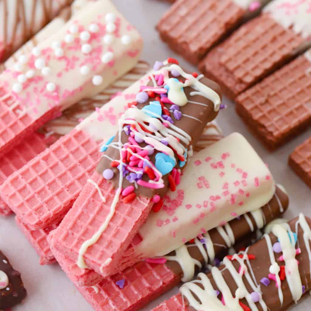 wafer cookies decorated for the holidays on parchment paper