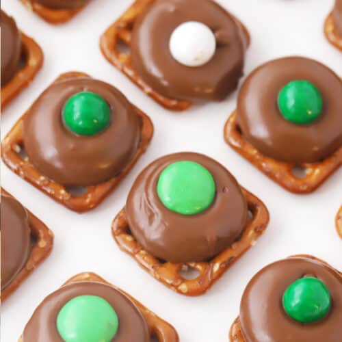 Rolo pretzel bites lined up on a baking sheet