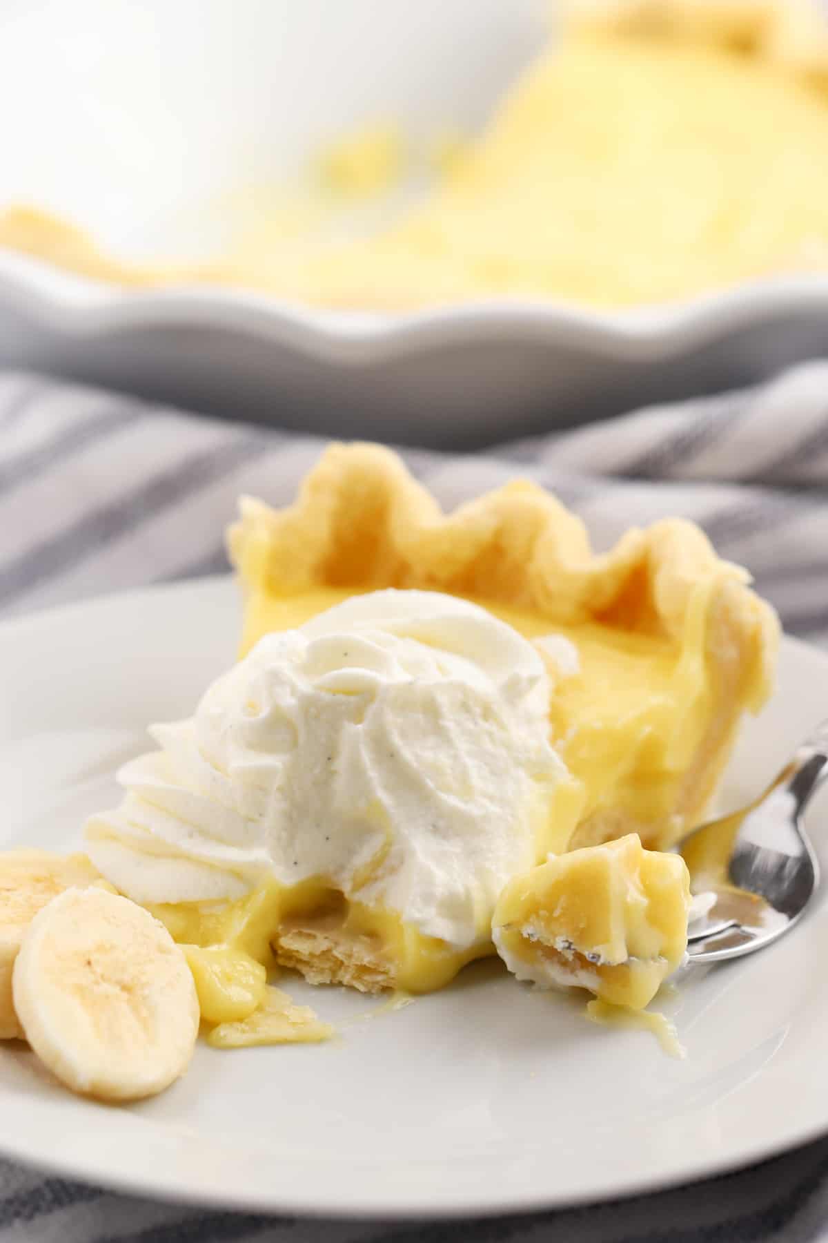 banana cream pie slice on a white plate