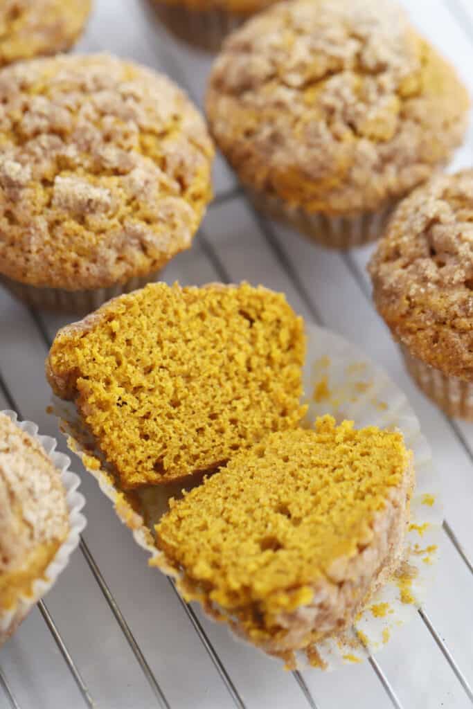 Baked pumpkin cake mix muffins cooling on a wire rack, pumpkin muffins from cake mix.