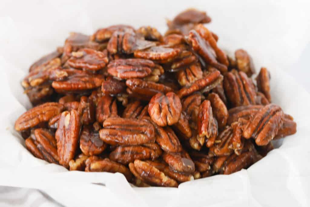 A bowl full of candied pecans, recipe for candied pecans. How to make candied pecans.