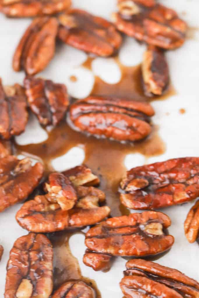 Glazed sweet pecans on a sheet tray, candied nuts recipe. how to candy nuts. 