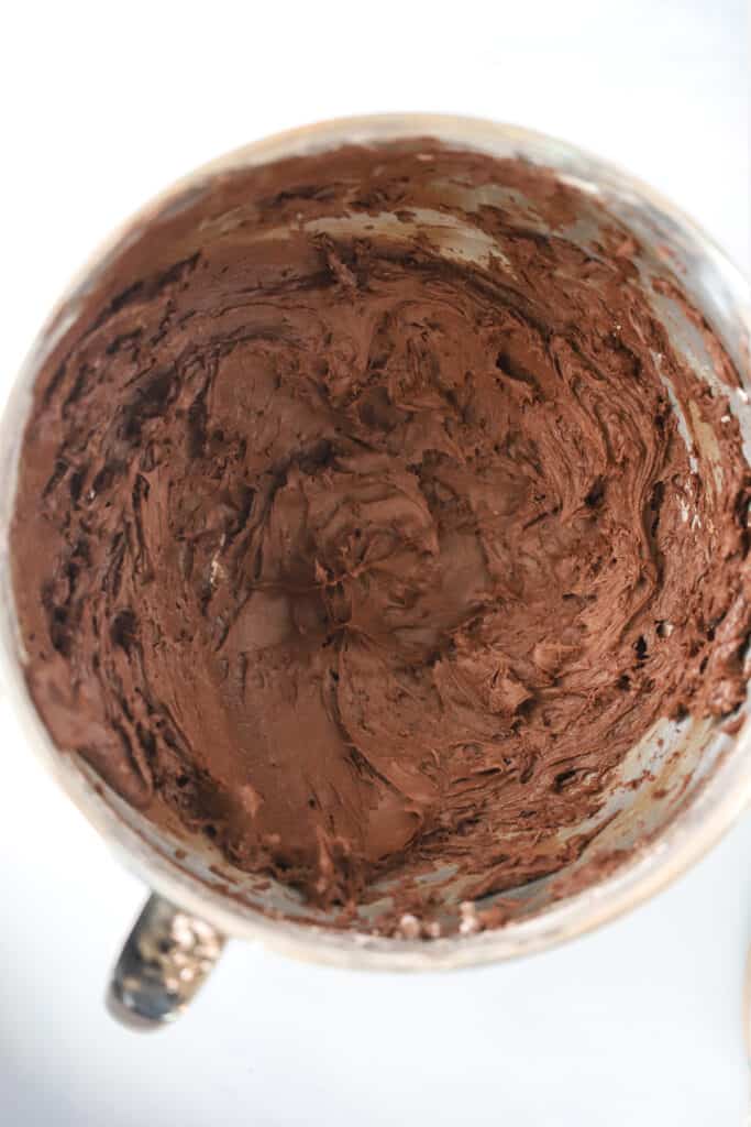 chocolate buttercream frosting recipe inside the bowl of a stand mixer. makes the best chocolate frosting recipe. 